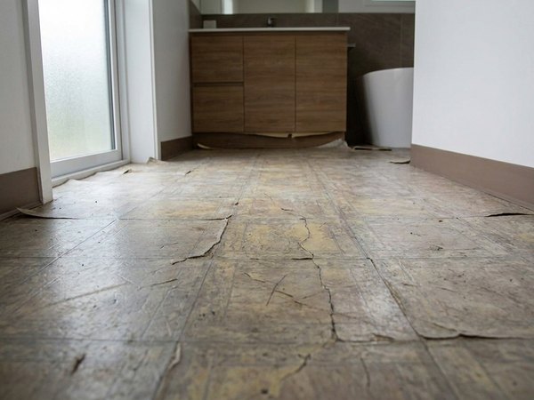 Worn bathroom floor before tile, example